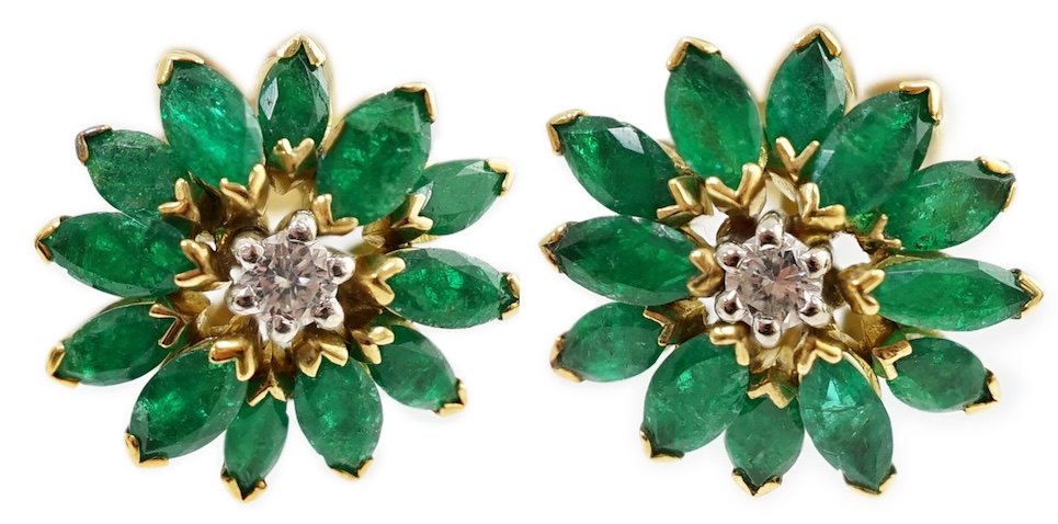 A modern pair of gold, emerald and diamond set flowerhead stud earrings